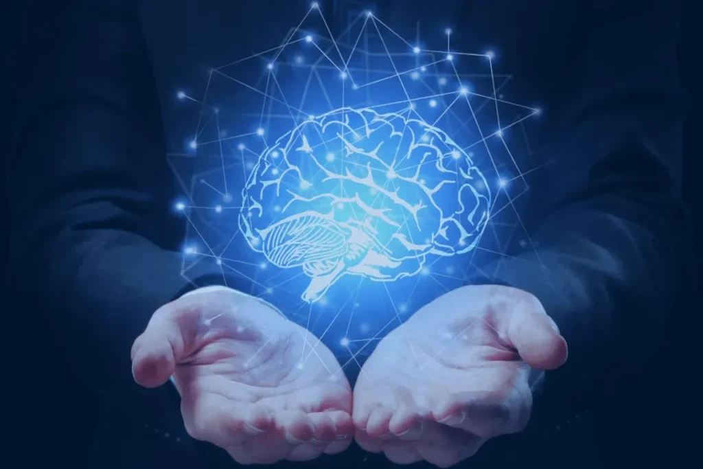 Representação digital de um cérebro com conexões neurais entre mãos humanas simbolizando inteligência e programação neurolinguística.